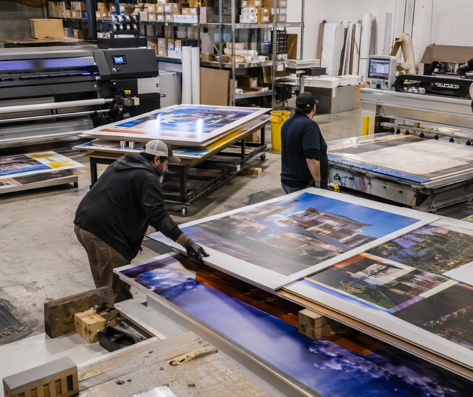 Complete CNC Solutions | Printed boards waiting at a CNC router in a busy sign production workshop