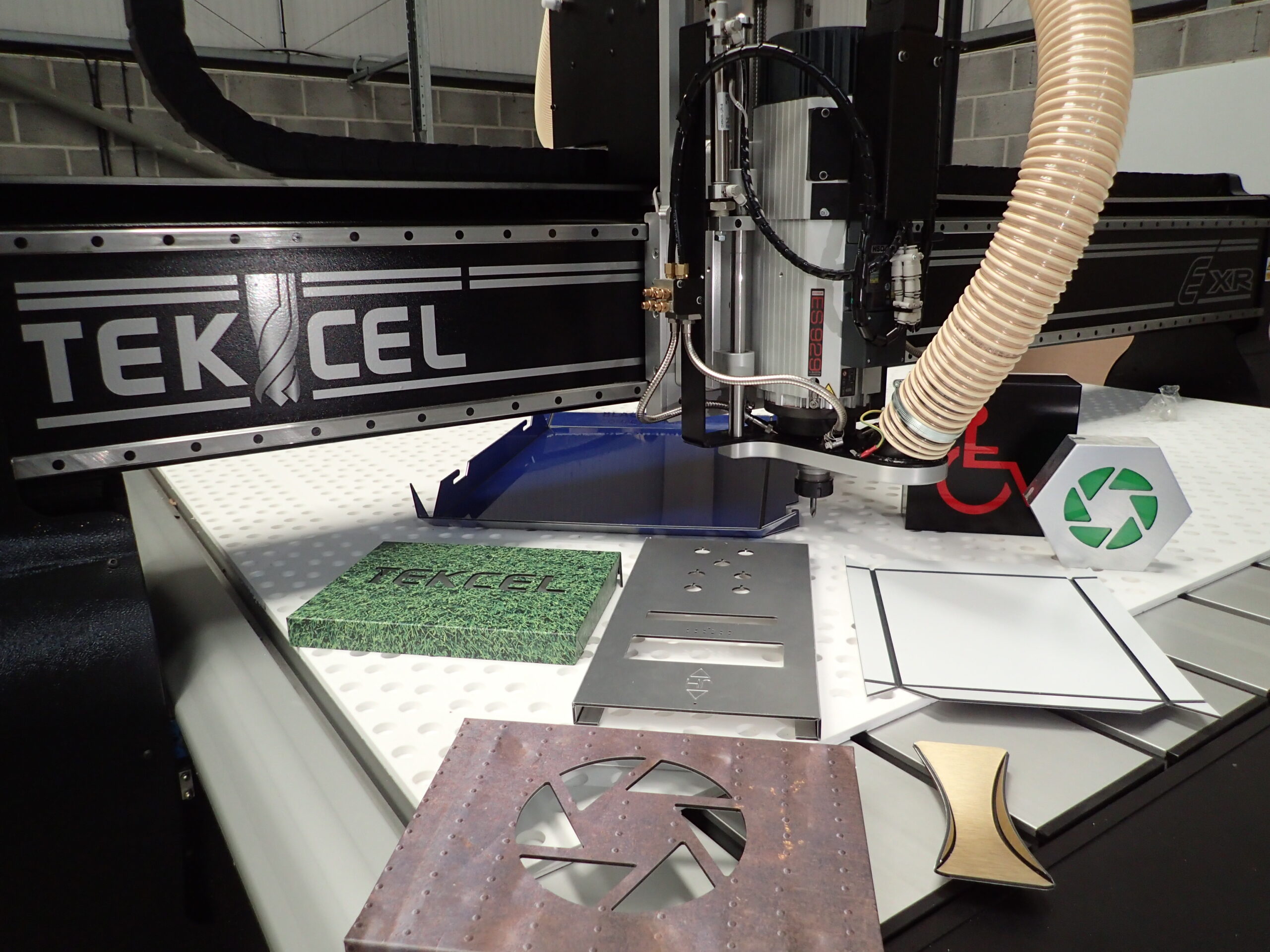 Complete CNC | Tekcel EXR CNC router with examples of cut and machined materials